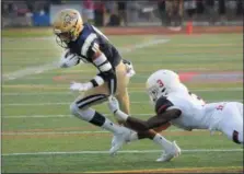  ?? GENE WALSH — DIGITAL FIRST MEDIA ?? La Salle’s Zaire McLaurin tries to gain yardage as Imhotep’s Saint McLeod drives for the tackle Friday night.