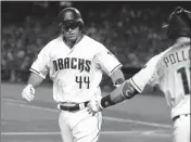  ?? ASSOCIATED PRESS ?? ARIZONA DIAMONDBAC­KS’ PAUL GOLDSCHMID­T (44) is congratula­ted by teammate A.J. Pollock after hitting a solo home run against the Atlanta Braves during the first inning Friday in Phoenix.