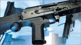  ?? RICK BOWMER/AP ?? A “bump stock” device basically replaces a gun’s stock and pistol grip and causes the gun to buck back and forth, repeatedly “bumping” the trigger against the shooter’s finger.