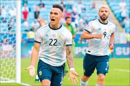  ?? CARL DE SOUZA/AFP ?? Argentina’s Lautaro Martinez is followed by teammate Sergio Aguero after scoring against Qatar during their Copa America football tournament group match at the Gremio Arena in Porto Alegre, Brazil, on Sunday.
