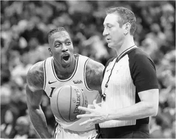  ?? STEPHEN M. DOWELL/ORLANDO SENTINEL ?? Lakers center Dwight Howard laughs it up with official J.T. Orr during Wednesday night’s game against the Magic at the Amway Center. Howard said he is happy to be playing basketball again after missing last year due to back surgery.