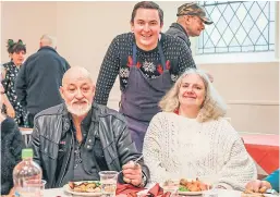  ?? Picture: Kris Miller. ?? Dean serves up food to Samuel Drummond and Carol Davidson at the Steeple Church helping to feed local people yesterday.