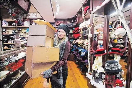  ?? JULIE JOCSAK THE ST. CATHARINES STANDARD ?? Chelsea Neufeld, shift leader at Beau Chapeau, holds some boxes ready to be shipped from their NOTL store on Monday.