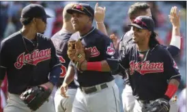  ?? LENNY IGNELZI — THE ASSOCIATED PRESS ?? The Indians jog off the field high-fiving each other after defeating the Angels on June 12 in Anaheim, Calif.