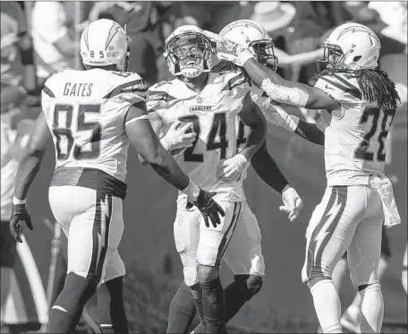  ?? Brian van der Brug Los Angeles Times ?? TREVOR WILLIAMS (24) of the Chargers celebrates his third-quarter intercepti­on that stopped a 49ers drive in the red zone during Sunday’s game at StubHub Center. The intercepti­on led to a field goal by Caleb Sturgis that extended the Chargers’ lead to nine points.