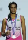  ?? — AP ?? India’s P. V. Sindhu poses with the silver medal after she was beaten by Japan’s Akane Yamaguchi during a final match of the Dubai Badminton World Superserie­s Finals on Sunday. ■ Report on Page 20