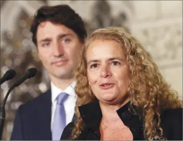  ?? Canadian Press photo ?? Prime Minister Justin Trudeau looks on as former astronaut, and Governor General designate, Julie Payette talks to reporters, on Parliament Hill, in Ottawa, Thursday.