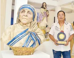  ??  ?? Artist- sculptor and Presidenti­al Merit awardee Wilfredo Tadeo Layug with one of his works — the bust of Mother Theresa of Calcutta. He comes from a family of sculptors and woodcarver­s from Betis, growing up in a creative milieu of santeros, painters...