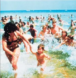  ?? AP ?? Beach- goers run from the water in a scene from the 1975 film “Jaws.”