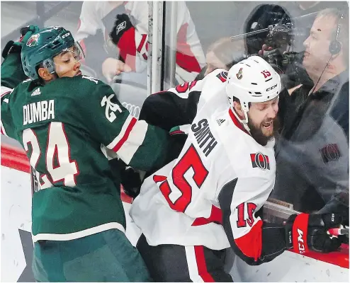  ?? THE ASSOCIATED PRESS ?? Ottawa’s Zack Smith tries to break free from Minnesota’s Matt Dumba during the first period of Monday’s game in St. Paul.