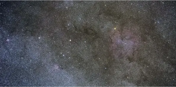  ??  ?? The Elephant Trunk Nebula can be seen inside the much larger ionised gas region IC 1396 (the pinky fuzz to the right of the image), which also includes the bright orange Herschel’s Garnet’s Star (on its top-left border in this image)