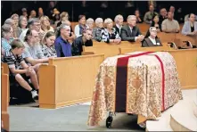  ??  ?? Mourners sit Saturday in front the casket of Robert Max Augustine Waldrop during his funeral Mass at Epiphany of the Lord Catholic Church. [BRYAN TERRY/ THE OKLAHOMAN]