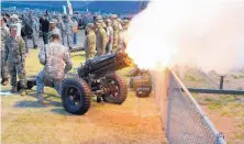  ??  ?? New Mexico State Army ROTC cadets Paola Estrada of El Paso, left, and Fernando River of Vado fire a World War II Pack 75 mm howitzer during ceremonies at the start of the Bataan Memorial Death March at White Sands Missile Range on Sunday.