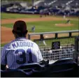  ?? CHARLIE RIEDEL — ASSOCIATED PRESS ?? A Chicago Cubs fan watches during Monday’s spring training game against the San Diego Padres in Peoria, Ariz.