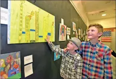  ?? Dan Watson/The Signal ?? From left: Brothers Sharky, 7, and Ryder Boyd, 10, stand by Sharky’s artwork entitled “My Favorite Heros Don’t Wear Capes” at the 50th annual Reflection­s Gala held at Meadows Elementary School Thursday.