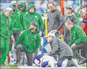  ?? Adam Hunger The Associated Press ?? Giants quarterbac­k Tyrod Taylor stays down after getting injured in the second quarter of a 13-10 overtime loss to the Jets.