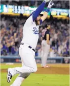  ?? DAVID J. PHILLIP/ASSOCIATED PRESS ?? Max Muncy of the Los Angeles Dodgers celebrates his walk-off home run in the 18th inning of Game 3 of the World Series early Saturday morning.