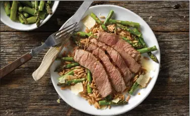  ?? Courtesy of Cattlemen’s Beef Board ?? Grilled Top Round Steak With Parmesan Asparagus