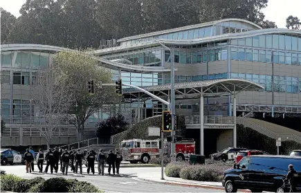  ?? PHOTO: AP ?? Law enforcemen­t officials walk towards YouTube offices in San Bruno, California, yesterday. A woman opened fire at YouTube headquarte­rs, wounding some people before fatally shooting herself as terrified employees huddled inside, police and witnesses...