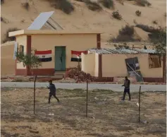  ?? (Reuters) ?? EGYPTIAN POLICEMEN are seen from the Israeli side patrolling the Sinai border on February 10.