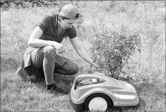  ?? FRAM DINSHAW/ TRURO NEWS ?? Stihl Canada’s small robotic lawnmower is designed to keep grass cut to a certain level and will return to its battery-charging station automatica­lly whenever its charge runs low. This eco-friendly machine was recently put through its paces in Valley by Stihl product specialist Josee Levesque from London, Ont.