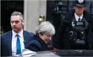  ?? AP ?? Police officers keep guard as Prime Minister Theresa May leaves 10 Downing Street. —