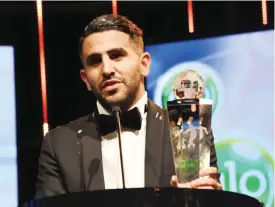  ?? — AFP ?? ABUJA: File photo shows Algerian and Leicester forward Riyad Mahrez holds a trophy after being crowned African Footballer of the Year in Abuja, on January 5, 2017.