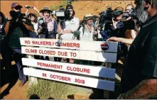  ?? KYODO NEWS AGENCY ?? A sign announcing the end to climbing Uluru is erected at the base of the iconic Australian monolith previously known as Ayers Rock, on Oct 25.