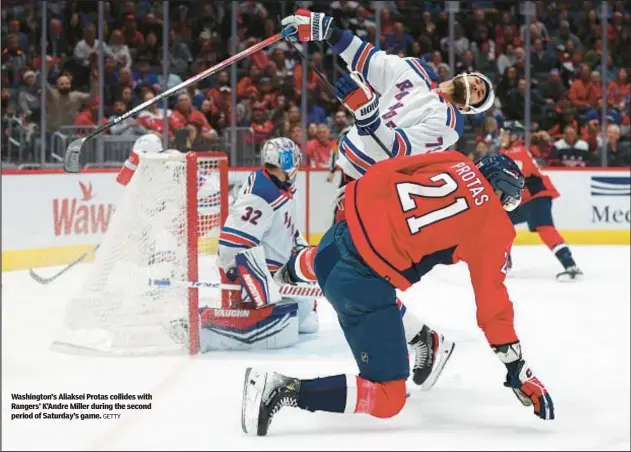  ?? GETTY ?? Washington’s Aliaksei Protas collides with Rangers’ K’Andre Miller during the second period of Saturday’s game.