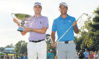  ?? Picture: Getty Images ?? CHAMPS. Justin Thomas (left) celebrates with the trophy after winning the FedExCup alongside American compatriot Xander Schauffele, who won the Tour Championsh­ip in Atlanta on Sunday.