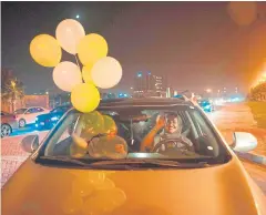  ?? AFP ?? A Saudi woman and her friend celebrate by driving on the main street of Khobar City for the first time yesterday.