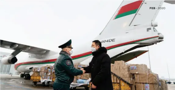  ?? by Duan Wei/china Pictorial ?? At 3 p.m. on February 6, 2020, an Ilyushin Il-76 carrying the second batch of Belarusian medical aid to China arrived at Beijing Capital Internatio­nal Airport. The parcels, weighing a total of 20 tons, consist of masks, gloves, protective suits, disinfecta­nt and other medical supplies. The photo shows Chinese representa­tive Liu Xuesong (right), deputy director-general of the Department of Eurasian Affairs of China’s Ministry of Commerce, extending thanks to Igor Bolotov, deputy minister of the Ministry of Emergency Situations of Belarus.