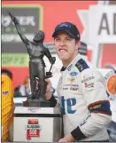  ?? The Associated Press ?? NASCAR driver Brad Keselowski holds up the trophy after winning the Alabama 500 at Talladega Superspeed­way on Sunday in Talladega, Ala.