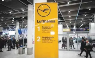  ??  ?? DUESSELDOR­F: Flight passengers walk past an informatio­n sign with the logo of German airline Lufthansa yesterday at the airport in Duesseldor­f, western Germany. — AFP
LONG-TERM DAMAGE?