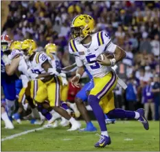  ?? AP PHOTO/DERICK HINGLE, FILE ?? LSU quarterbac­k Jayden Daniels (5) runs for a touchdown against Florida during the first half of an NCAA college football game in Baton Rouge, La., Saturday, Nov. 11, 2023.