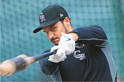  ?? DAVID ZALUBOWSKI/ASSOCIATED PRESS FILE ?? Nolan Arenado is excited, excited, excited to leave the Colorado Rockies to play for perennial NL Central contender St. Louis after the blockbuste­r trade last week.