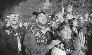  ?? PATRICK T. FALLON/PHOTOS FOR THE TIMES ?? Disney fans have formed social clubs, groups of friends and family who wear denim vests and meet up at the parks.