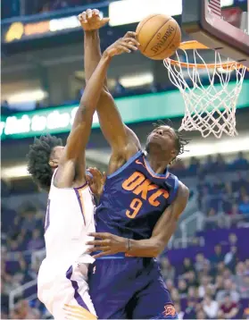  ?? PHOTO/RICK SCUTERI) (AP ?? DENIED. Oklahoma City Thunder forward Jerami Grant blocks a shot by Phoenix Suns forward Josh Jackson.