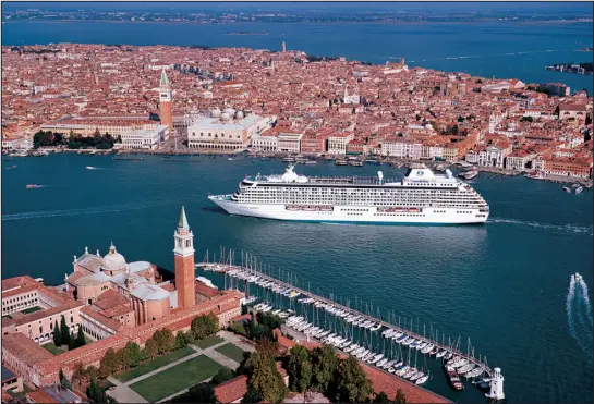  ?? TRIBUNE NEWS SERVICE FILE ?? A cruise ship approaches Venice, Italy. From April 25through mid-july, day visitors to the historic part of the city will have to pay about $5; city officials hope to encourage people to visit during less-busy times.