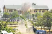  ?? AFP ?? Smoke rises from the BSF building in Srinagar after it was attacked by militants on Tuesday.