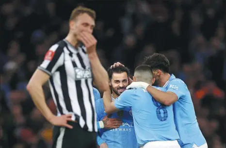  ?? ACTION IMAGES VIA REUTERS ?? Bernardo Silva is congratula­ted by teammates after netting Manchester City’s second goal to seal a 2-0 FA Cup quarterfin­al win over Newcastle United at the Etihad Stadium on Saturday.