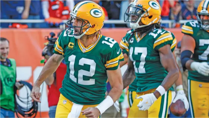  ?? KAMIL KRZACZYNSK­I/AP ?? Packers quarterbac­k Aaron Rodgers celebrates with teammates after scoring a touchdown during the second half on Oct. 17. After the score, he famously told Bears fans, ‘‘I still own you.’’