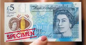  ?? — Photos: AP ?? a file photo of a bank of england employee showing the new five pound note at the bank of england Museum in London in 2016.