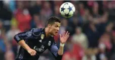  ?? AFP/GETTY IMAGES ?? Real Madrid striker Cristiano Ronaldo heads the ball during a Champions League match against Bayern Munich on Wednesday.