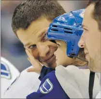  ?? ARLEN REDEKOP/ PNG ?? Vancouver Canucks defenceman Kevin Bieksa holds daughter Reese during Sunday’s annual superskill­s competitio­n at Rogers Arena. On Monday, dad was among the ‘ guinea pigs’ wearing a heart monitor at the team’s morning practice.