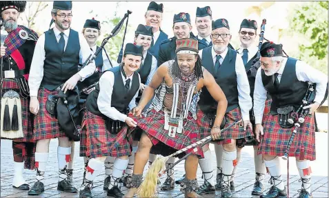  ?? Picture: MIKE HOLMES ?? RHYTHMS OF AFRICA: The Algoa Caledonian Pipe Band’s Beverley Scott examines traditiona­l healer (Igqirha) Zamuxolo Mgoduka’s kilt, which stems from Scottish influence in Tsolo where he was trained. They were all at the City Hall Heritage Day...