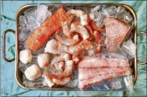  ??  ?? You can find seafood in metro Atlanta, including (clockwise starting from top left) salmon fillets, Gulf shrimp, tuna steaks, barramundi fillets and sea scallops.