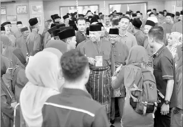  ??  ?? Ahmad Zahid being greeted upon arrival for the opening of Bagan Datuk Umno division delegates meeting. — Bernama photo