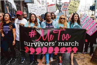  ?? Damian Dovarganes/Associated Press file ?? #MeToo founder Tarana Burke, center, marches in 2017 in Hollywood. After one of Harvey Weinstein’s rape conviction­s was overturned Thursday, Burke vowed the movement was still alive.