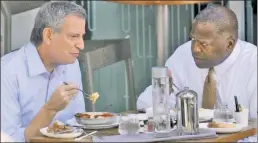  ??  ?? TOUGH DAY AT THE OFFICE: Mayor de Blasio and Mayor Stephen Benjamin of Columbia, SC, chow down in Miami Beach in June.